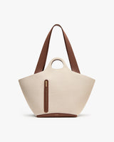 Large tote bag with a frontal zipper pocket, circular handle, and long strap.