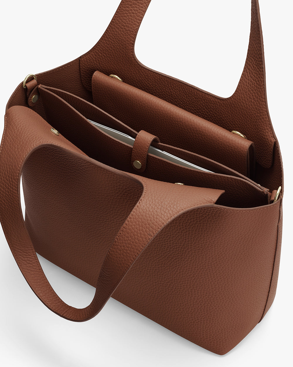 Open handbag with multiple compartments and snap buttons
