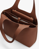 Open handbag with multiple compartments and snap buttons