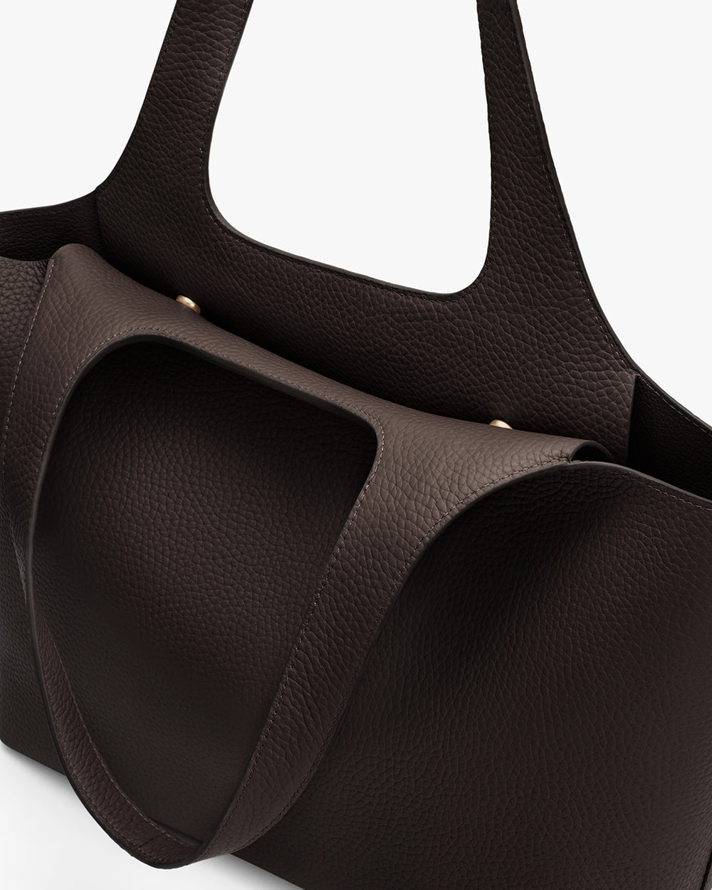 Close-up of a textured handbag with two handles.