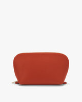 Small rounded pouch with a zipper on a light background