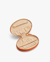 Open jewelry case with compartments.