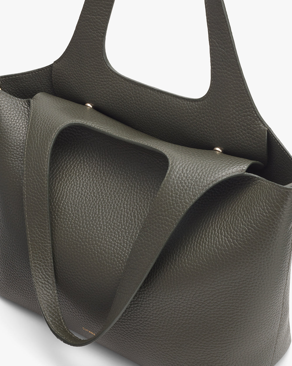 Close-up view of a textured tote bag with two handles.