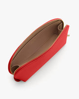 Open small purse with zipper, showing interior compartments.