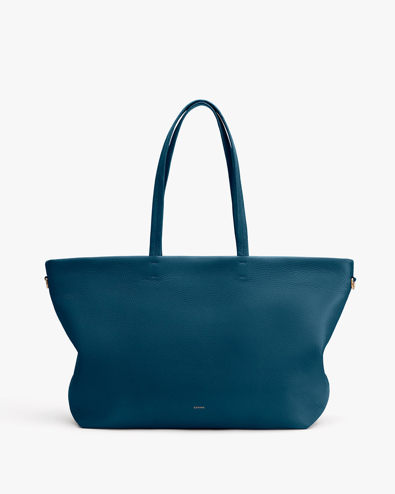 Large tote bag with two handles on plain background.