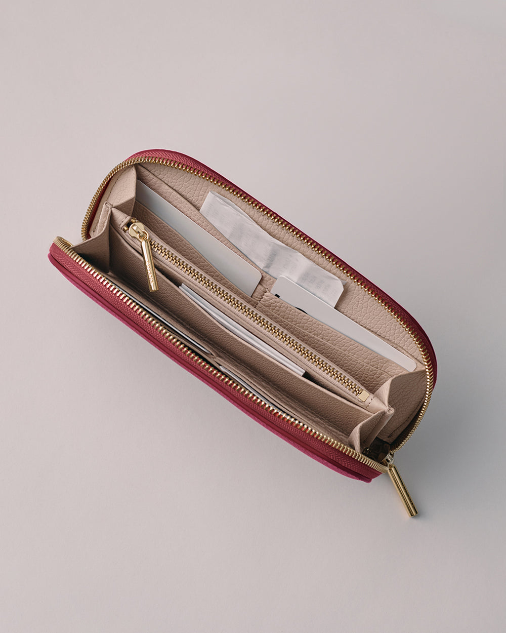 Opened wallet displaying multiple compartments and a zipper pocket.