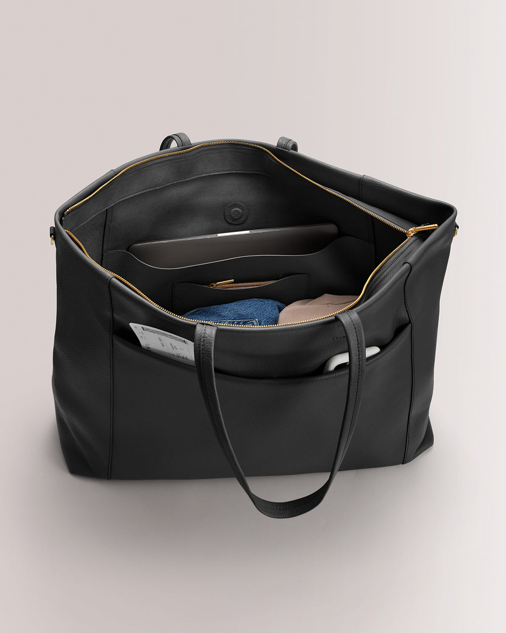 Large open tote with organized interior pockets and visible contents.