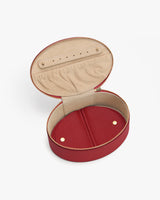 Open round jewelry case with zipper and interior compartments.
