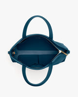 Open handbag showing interior pockets and zipper.