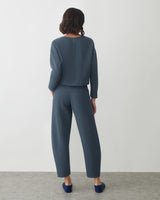 Person wearing a matching top and trousers facing away.