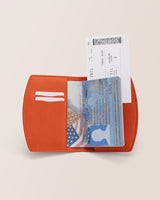Wallet with a passport and a boarding pass partially visible.