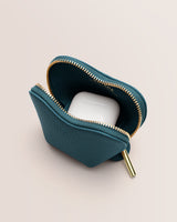 Small zippered pouch holding wireless earbuds case.