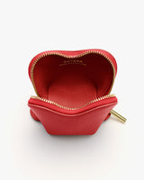 Small leather pouch with open zipper and visible branding inside.