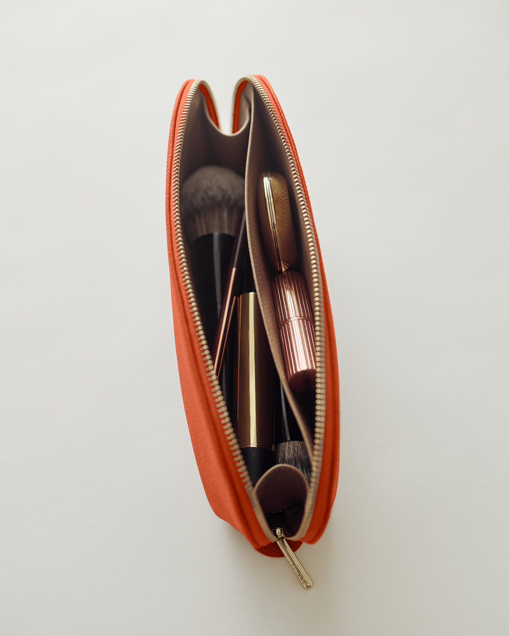 Makeup bag open showing brushes and cosmetics inside.