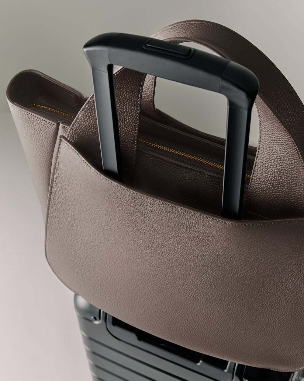 Travel bag on suitcase handle.