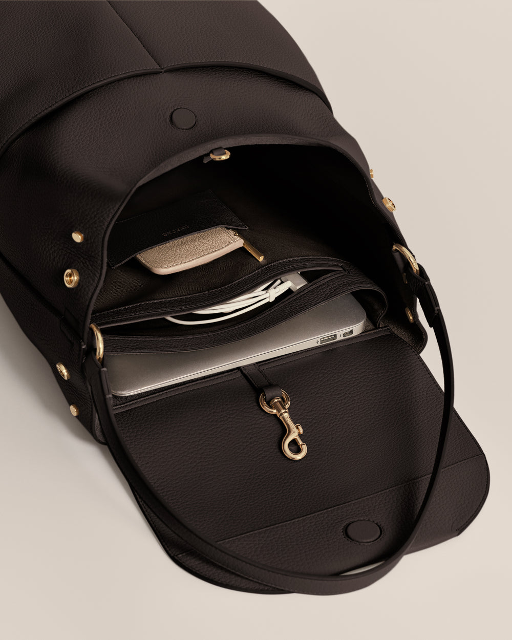 Open travel bag showing laptop and other items inside.