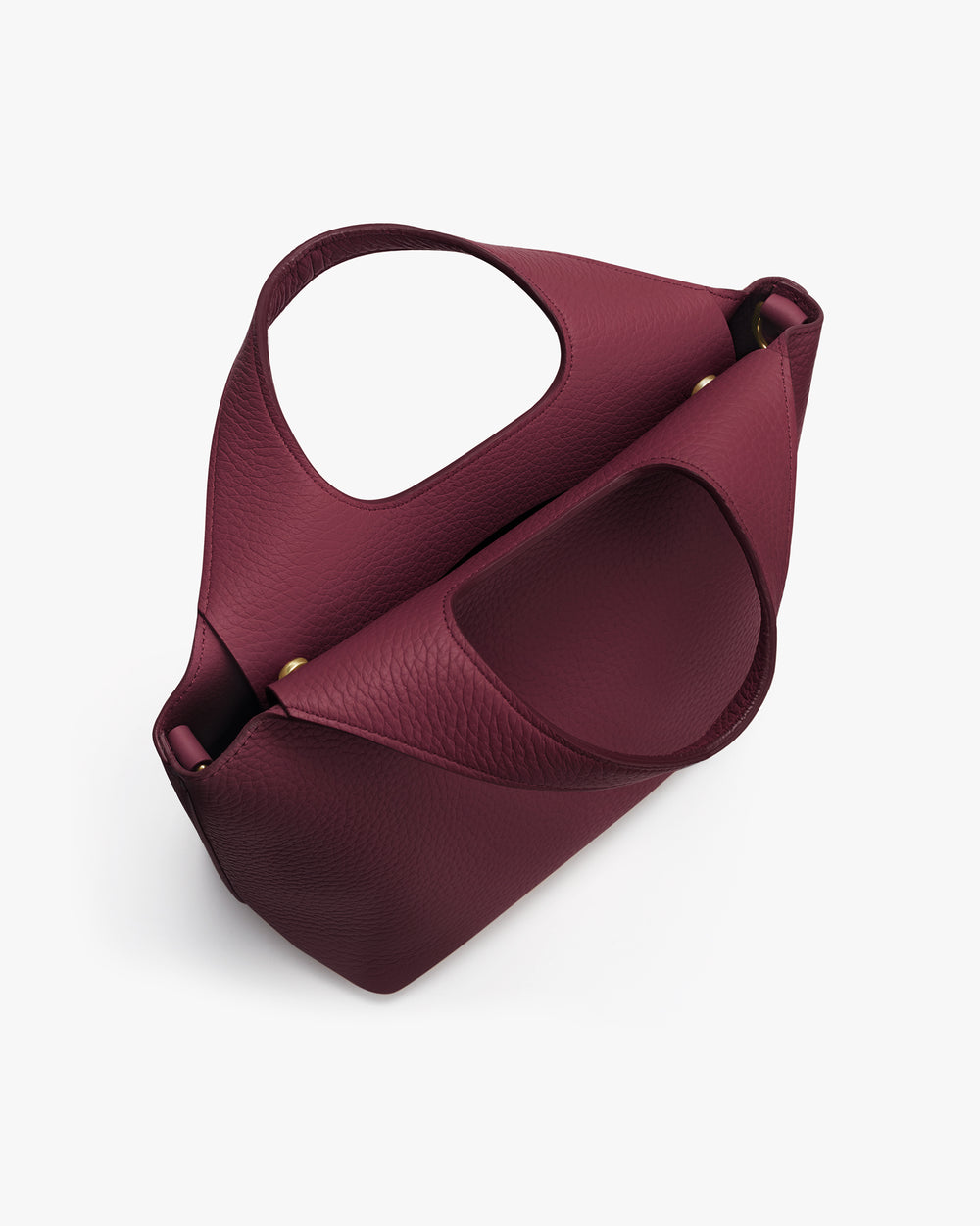 Handbag with circular cutout handle viewed from top angle.