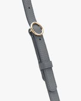 Leather belt with metal ring buckle and adjustable strap.
