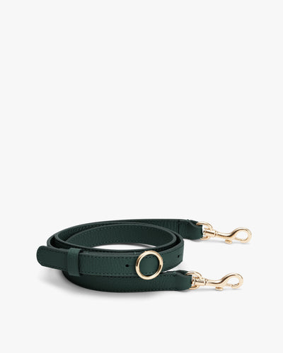 Adjustable strap with metal clasps and a circular buckle detail.