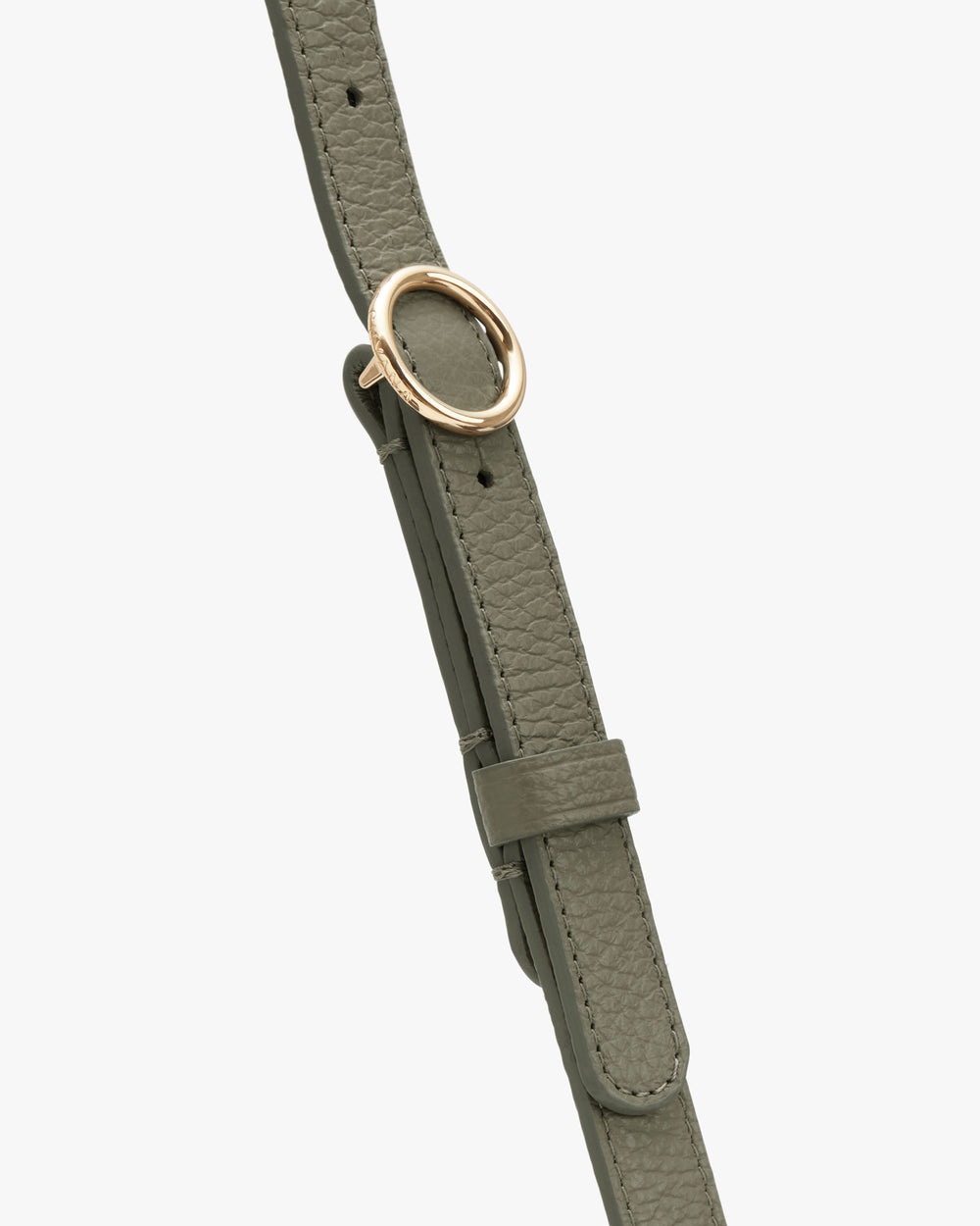 Close-up of a strap with a metal ring buckle and adjustable loop.