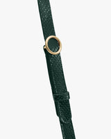 Strap with croc-embossed leather and circular metal buckle.