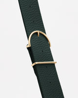 Close-up of a textured belt with a metal buckle.
