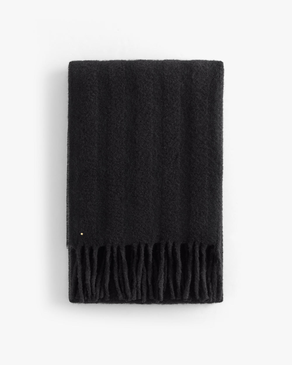 Rectangular scarf with fringed ends folded neatly