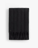 Rectangular scarf with fringed ends folded neatly