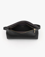Belt bag with open zipper and visible interior with handle on both sides.