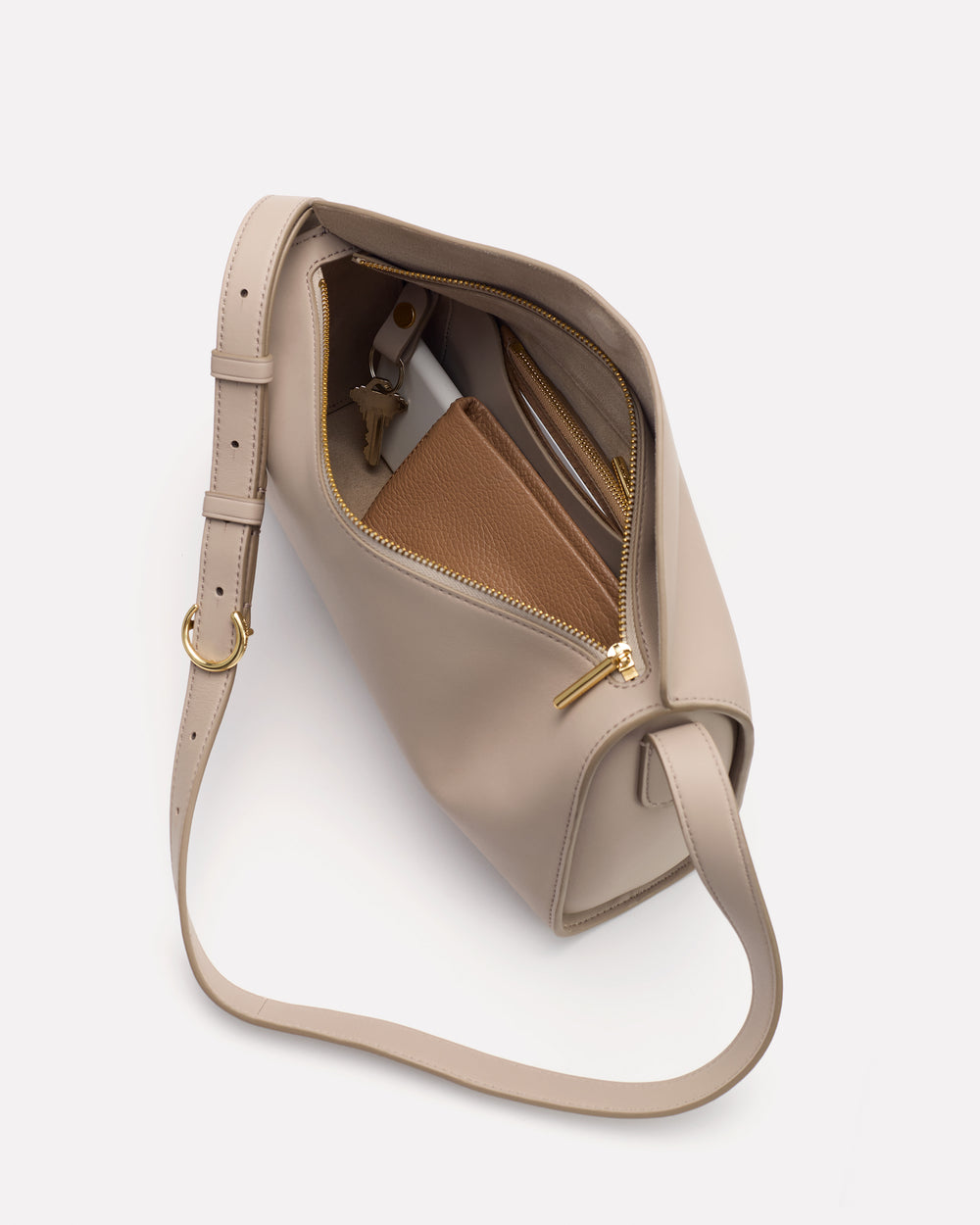 Open shoulder bag with contents visible inside, including a zippered pouch.