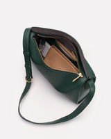 Open handbag with a visible pocket and strap lying beside it.