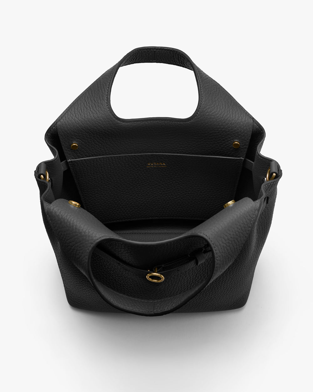 Open handbag with visible interior, handles, and gold-tone accents.