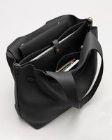 An open tote bag with multiple compartments and gold button accents.
