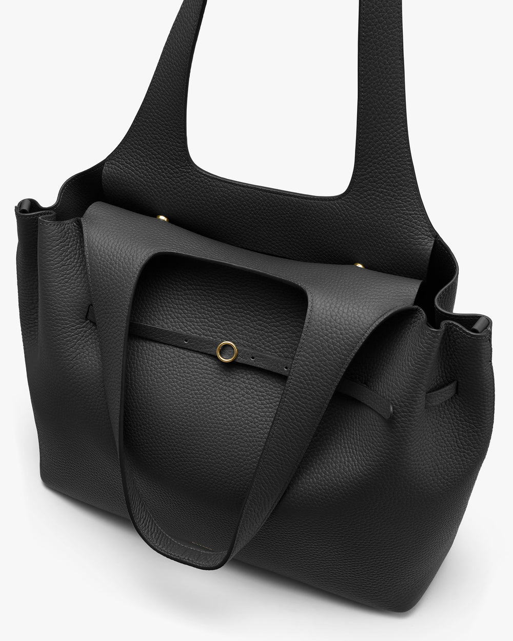 Tote bag with a circular metal accent on textured fabric.