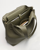 Open tote bag with items inside viewed from above.