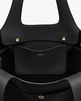 Open tote bag with interior pocket and gold button details.