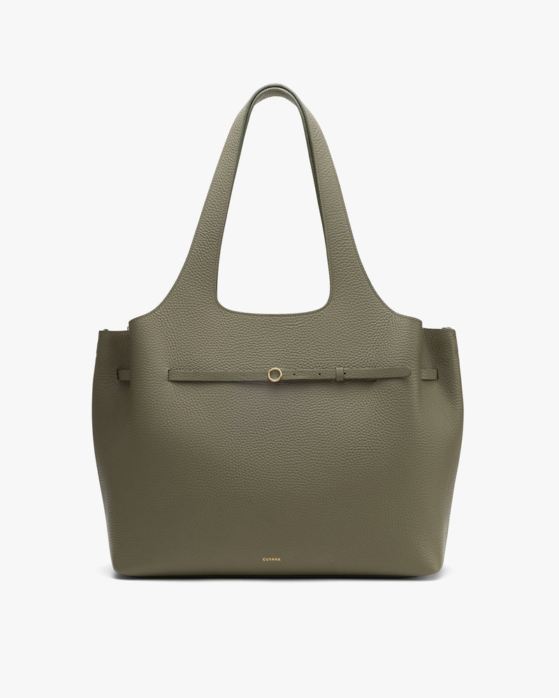 Tote bag with a textured surface and a front strap detail.