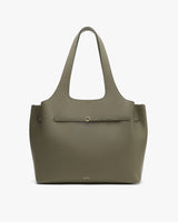 Tote bag with a textured surface and a front strap detail.