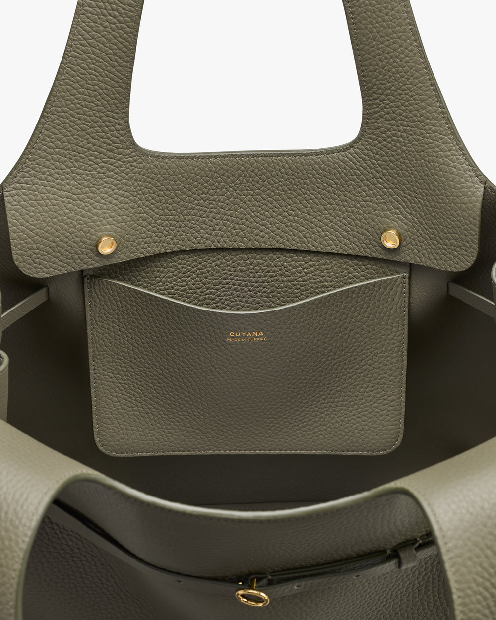 Open handbag with textured finish and interior pocket with gold accents.