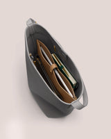 Tote bag filled with folders and a notebook.