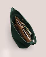 Open handbag with pockets, papers, and items inside.
