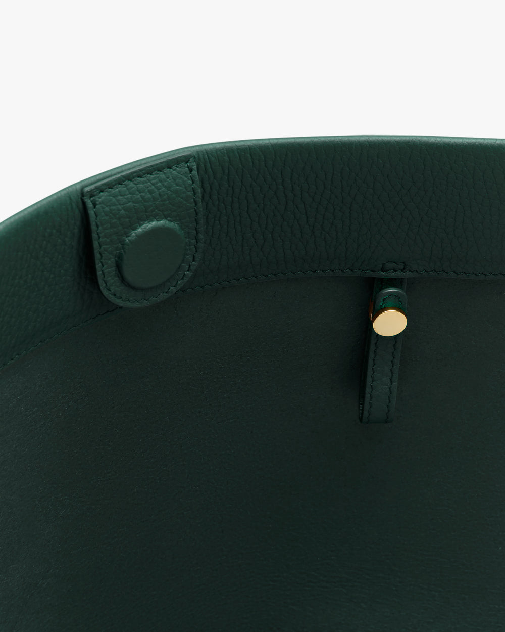 Inside view of an open handbag with a button clasp.