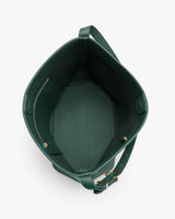 Open top view of an empty handbag with a strap on side.