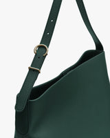 Shoulder bag with adjustable strap and metal buckle.