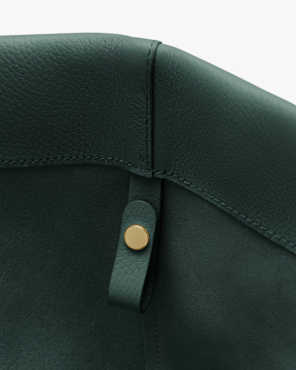 Close-up of leather bag interior with button detail.