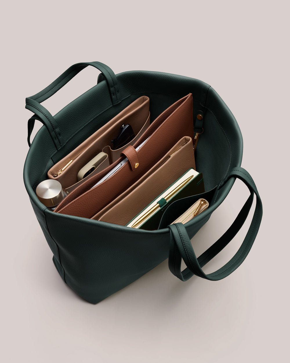 Open tote bag with organized items inside, including wallets and a phone.