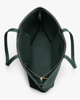 Open top view of a spacious handbag with a zippered edge.