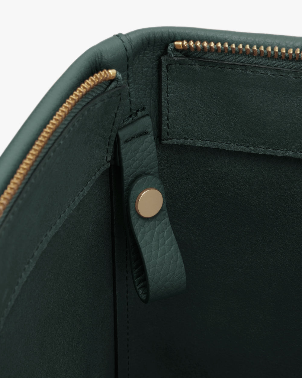 Close-up of a zippered bag opening with a snap button.