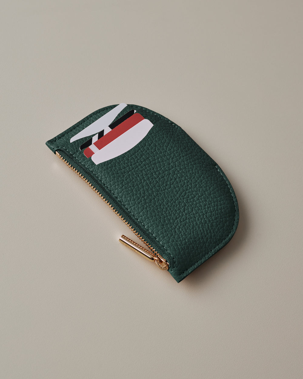 Textured zipper pouch with cards partially visible.