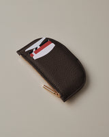 Wallet with cards peeking out, displayed on a plain surface.